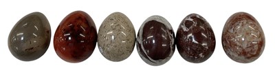 Lot 324 - Six carved hardstone eggs comprising three...