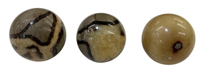 Lot 329 - Three carved hardstone serpentine spheres, all...