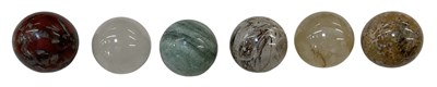 Lot 331 - Six assorted carved hardstone spheres,...