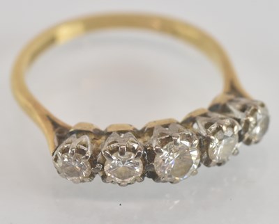 Lot 1246 - An 18ct yellow gold and platinum diamond five...