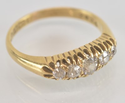 Lot 1245 - An 18ct yellow gold diamond five stone ring,...