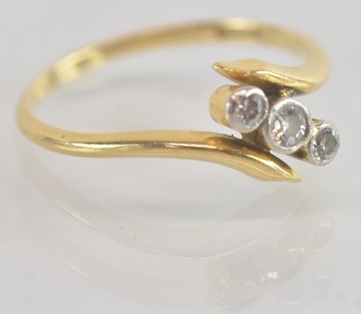 Lot 1250 - An 18ct yellow gold diamond three stone...
