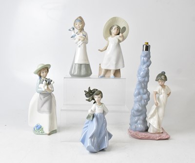 Lot 235 - NAO; a lamp base with a figure of a young girl,...