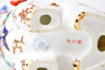 Lot 394 - YOSHIMI K; a pair of porcelain lion dogs,...
