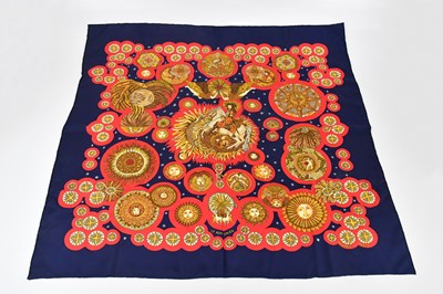 Lot 684 - HERMÈS; a 100% silk twill 'Le Roy Soleil' red,...