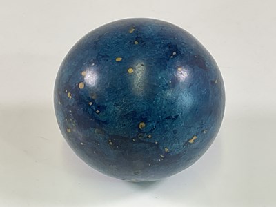 Lot 58 - A wooden ball with painted simulated blue...