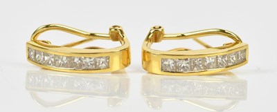 Lot 173 - A pair of yellow metal diamond set half hoop...