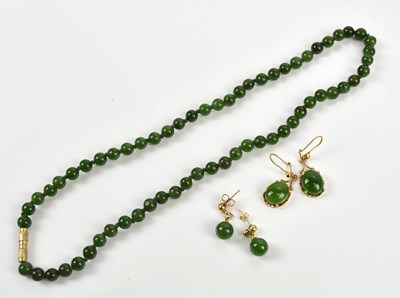 Lot 261 - A Chinese green hardstone bead necklace,...