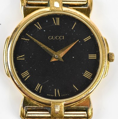 Lot 564 - GUCCI; a gentleman's gold plated wristwatch,...
