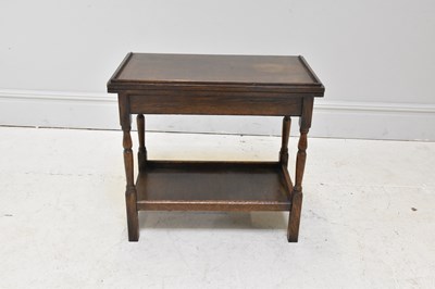 Lot 197 - An early 20th century oak fold-over card table,...