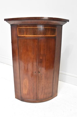 Lot 43 - A Georgian inlaid mahogany corner cupboard,...