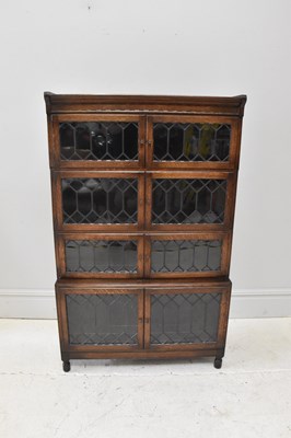 Lot 91 - An oak freestanding bookcase, with leaded...