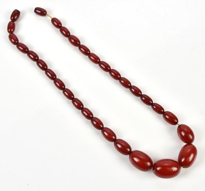 Lot 295 - A cherry amber coloured beaded necklace,...