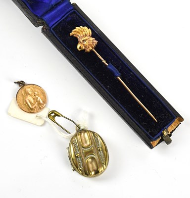 Lot 12 - A yellow metal pendant representing Madonna...