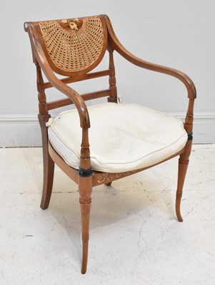 Lot 1092 - A Regency style cane seated painted arm chair.