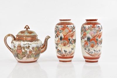 Lot 1555 - A pair of Kutani vases, both with character...