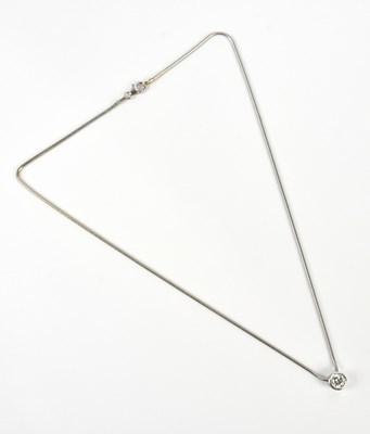 Lot 212 - A diamond set pendant suspended on a white...