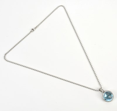 Lot 242 - An 18ct white gold diamond and blue topaz set...