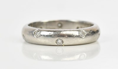 Lot 455 - TIFFANY; a platinum diamond set wedding band,...