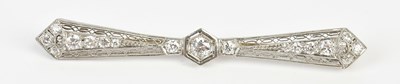 Lot 69 - An Art Deco white metal diamond set bow brooch,...