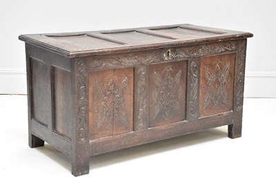 Lot 42 - An 18th century carved and panelled oak coffer,...