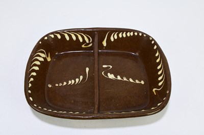 Lot 652 - A 19th century slipware two division dish,...