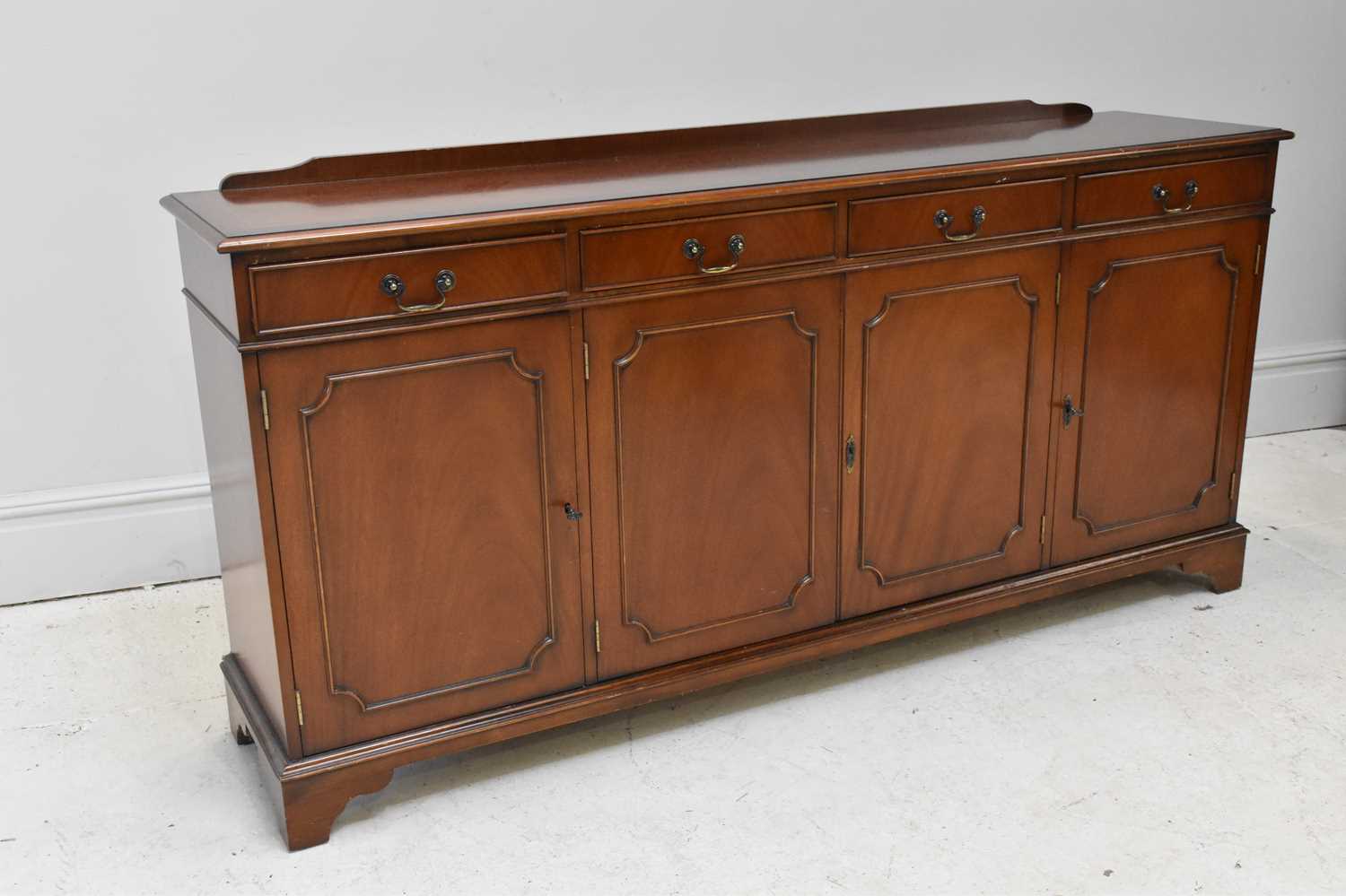 Lot 1048 - A reproduction mahogany sideboard with four
