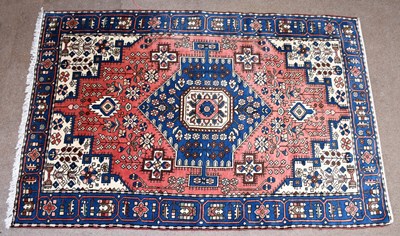 Lot 2679 - A large rug with stylised floral decoration on...