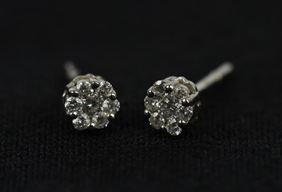 Lot 183 - A pair of white metal diamond set cluster ear...