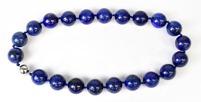 Lot 868 - A lapis lazuli necklace of twenty-one beads,...