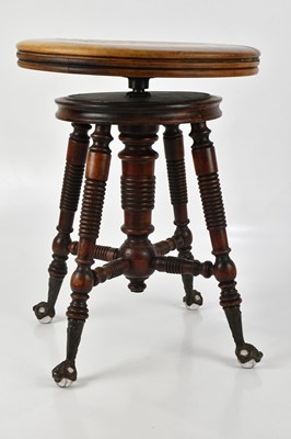 Lot 1161 - A 19th century mahogany piano stool, with calf...