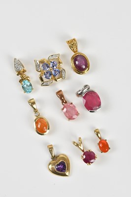 Lot 244 - Nine yellow metal gem set pendants stamped '9C'...