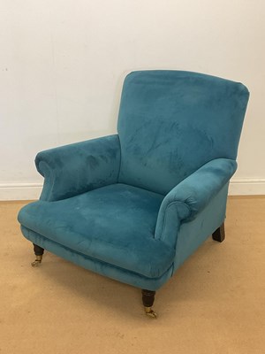 Lot 379 - A blue upholstered low armchair, raised on...
