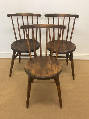 Lot 418 - A set of three beech stick back chairs, raised...
