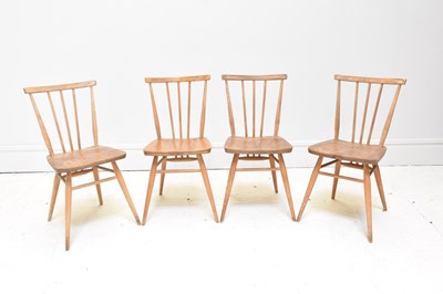 Lot 1003 - ERCOL; a set of four light elm spindle back...