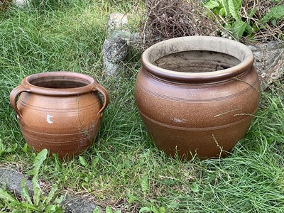 Lot 1246 - Two glazed terracotta plant pots, larger...