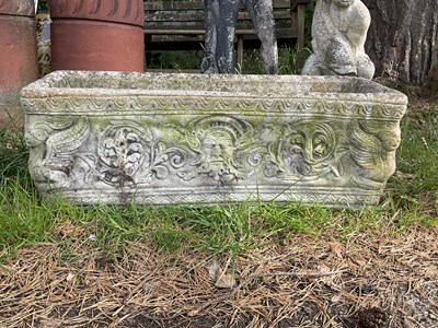 Lot 1234 - A reconstituted stone garden trough, decorated...
