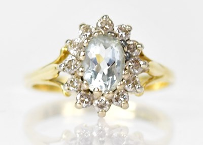Lot 807 - A 9ct gold ring set with a pale blue central...