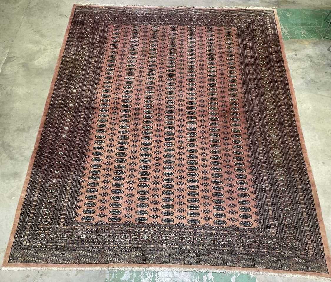 Lot 347 - A large machine woven Persian Bokhara rug,