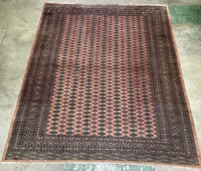 Lot 347 - A large machine woven Persian Bokhara rug,...
