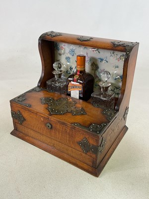 Lot 51 - A 19th century oak tantalus with integrated...