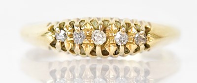 Lot 803 - An 18ct yellow gold ring set with five small...
