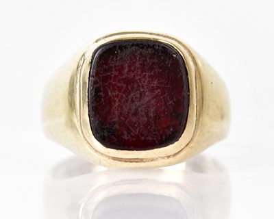 Lot 821 - A yellow metal signet ring set with a square...