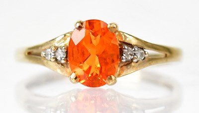 Lot 813 - A 9ct gold ring set with an orange stone and...