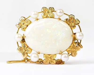 Lot 843 - A yellow metal brooch set with an oval opal in...