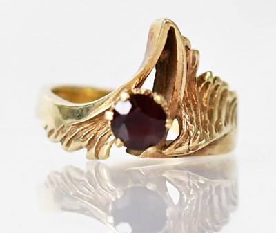 Lot 818 - A 9ct gold ring set with a garnet in a...