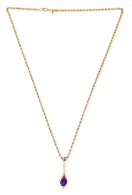 Lot 855 - A 9ct gold pendant set with a pear-shaped...