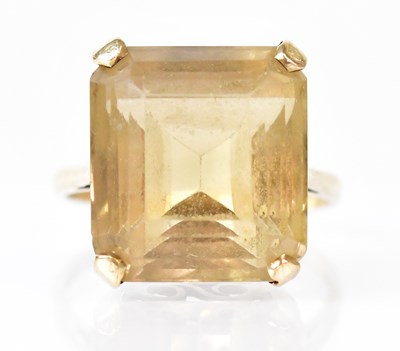 Lot 811 - A 9ct gold ring claw-set with a faceted pale...