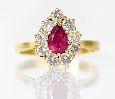 Lot 798 - An 18ct gold cluster ring set with a central...