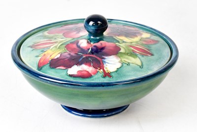 Lot 296 - MOORCROFT; a 'Hibiscus' pattern lidded bowl of...